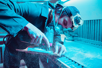 Image showing Skater in process of making his own skateboard, longboard - open business concept