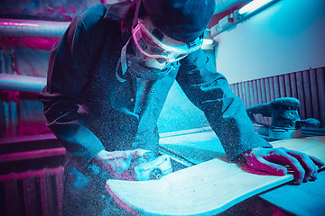 Image showing Skater in process of making his own skateboard, longboard - open business concept