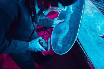 Image showing Skater in process of making his own skateboard, longboard - open business concept