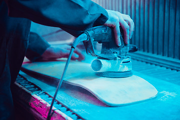 Image showing Skater in process of making his own skateboard, longboard - open business concept