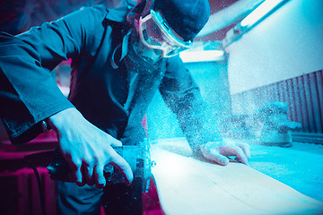 Image showing Skater in process of making his own skateboard, longboard - open business concept