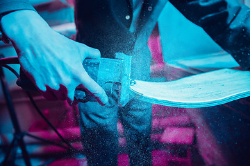 Image showing Skater in process of making his own skateboard, longboard - open business concept