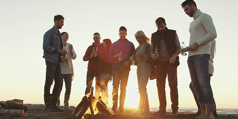 Image showing Friends having fun at beach on autumn day