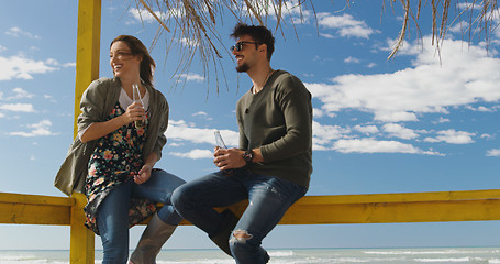 Image showing Group of friends having fun on autumn day at beach