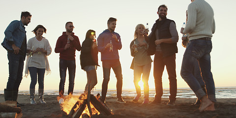 Image showing Friends having fun at beach on autumn day