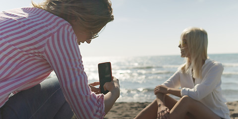 Image showing Two girl friends having fun photographing each other on vecation