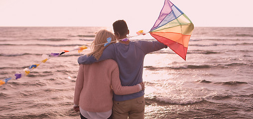 Image showing Happy couple having fun with kite on beach