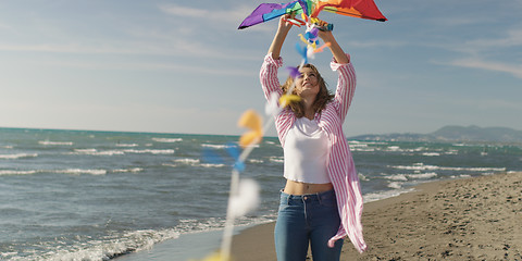 Image showing Happy couple having fun with kite on beach