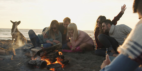 Image showing Friends Relaxing At Bonfire Beach Party