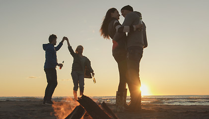 Image showing Friends having fun at beach on autumn day