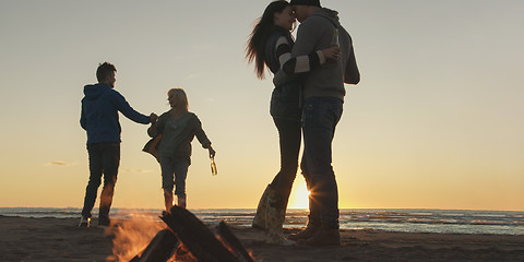 Image showing Friends having fun at beach on autumn day