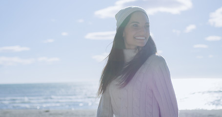 Image showing Girl In Autumn Clothes Smiling on beach