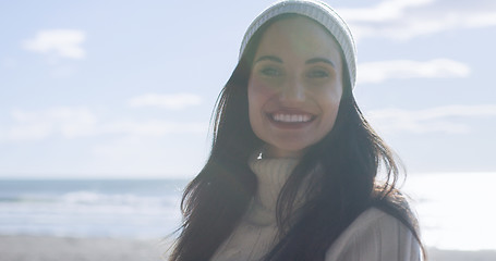 Image showing Girl In Autumn Clothes Smiling on beach