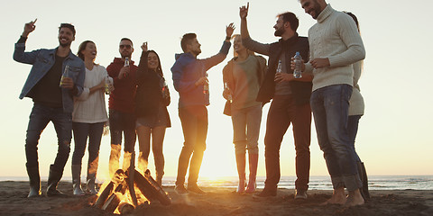 Image showing Friends having fun at beach on autumn day