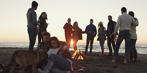 Image showing Friends having fun at beach on autumn day