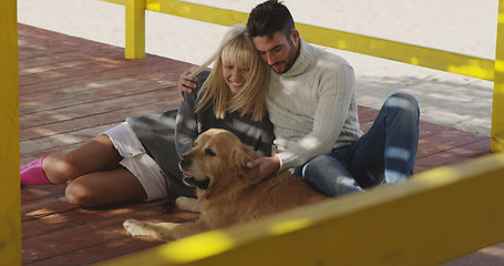 Image showing Couple with dog enjoying time on beach