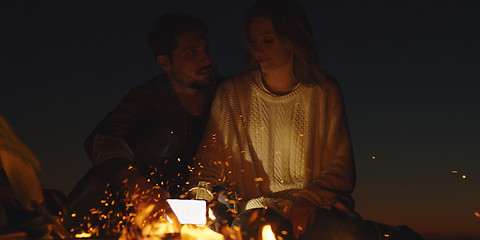 Image showing Couple enjoying with friends at night on the beach