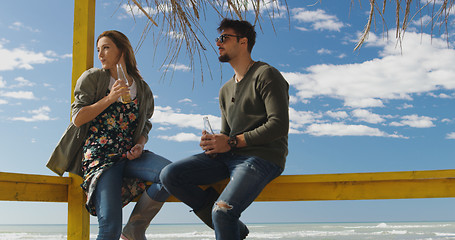 Image showing Group of friends having fun on autumn day at beach