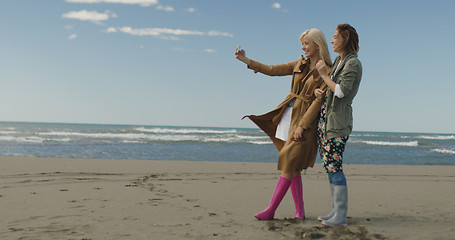 Image showing Girls having time and taking selfie on a beach