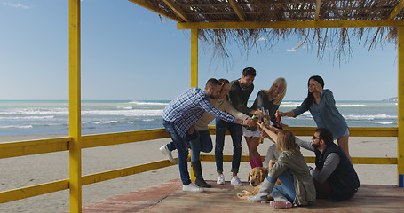 Image showing Group of friends having fun on autumn day at beach