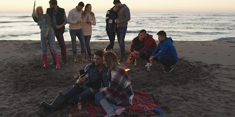 Image showing Friends having fun at beach on autumn day