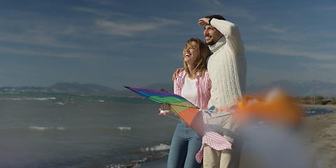 Image showing Happy couple having fun with kite on beach