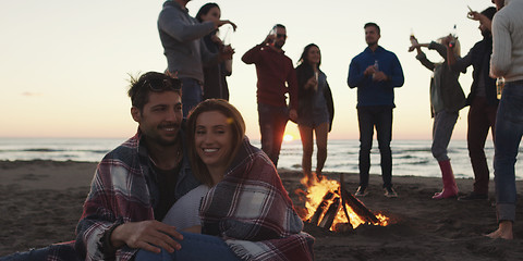 Image showing Friends having fun at beach on autumn day