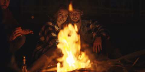 Image showing Couple enjoying with friends at night on the beach