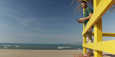 Image showing Man Operating Drone By The Sea