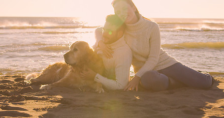 Image showing Couple with dog enjoying time on beach