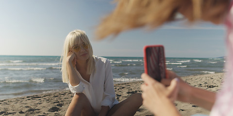 Image showing Two girl friends having fun photographing each other on vecation