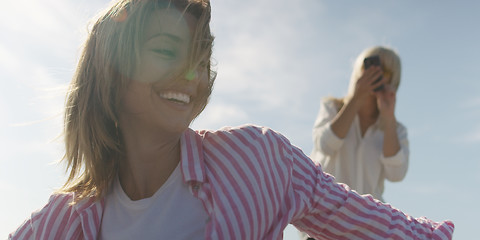 Image showing Two girl friends having fun photographing each other on vecation