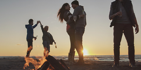 Image showing Friends having fun at beach on autumn day