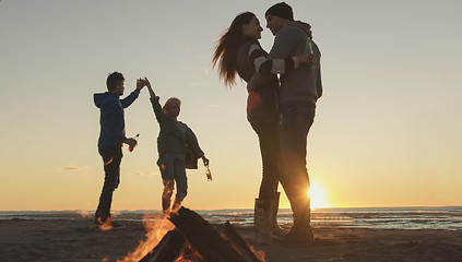 Image showing Friends having fun at beach on autumn day