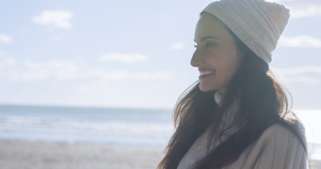 Image showing Girl In Autumn Clothes Smiling on beach