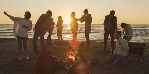 Image showing Friends having fun at beach on autumn day