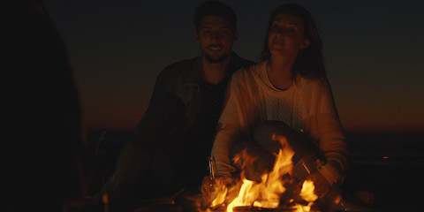 Image showing Couple enjoying with friends at night on the beach