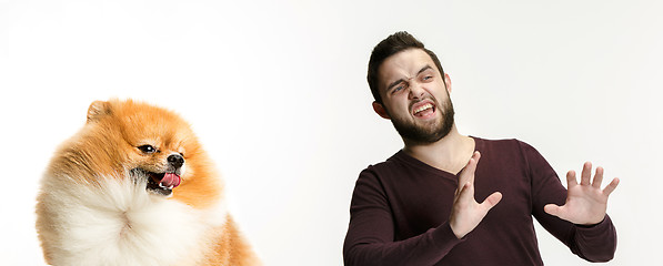 Image showing Emotional Portrait of a man and his dog, concept of friendship and care of man and animal