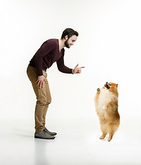 Image showing Emotional Portrait of a man and his dog, concept of friendship and care of man and animal