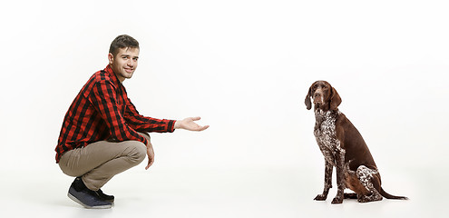 Image showing Emotional Portrait of a man and his dog, concept of friendship and care of man and animal