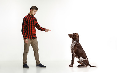 Image showing Emotional Portrait of a man and his dog, concept of friendship and care of man and animal