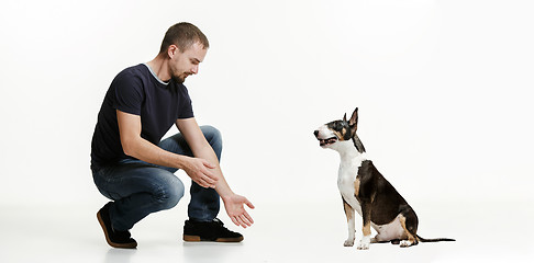 Image showing Emotional Portrait of a man and his shepherd dog, concept of friendship and care of man and animal