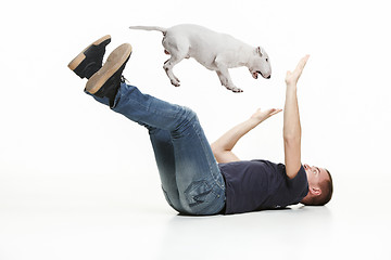 Image showing Emotional Portrait of a man and his Bull Terrier dog, concept of friendship and care of man and animal