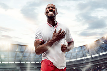 Image showing The football player in motion on the field of stadium