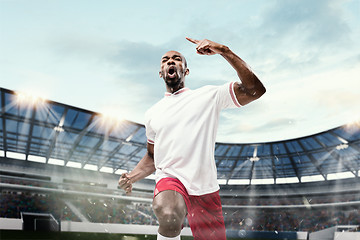 Image showing The football player in motion on the field of stadium