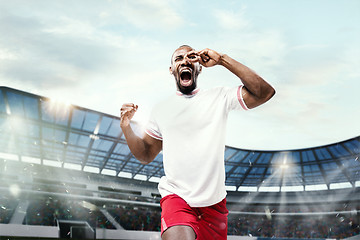 Image showing The football player in motion on the field of stadium