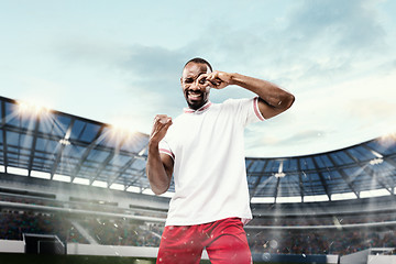 Image showing The football player in motion on the field of stadium