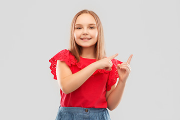 Image showing smiling girl pointing fingers to something