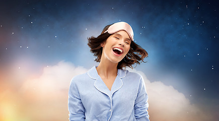 Image showing happy young woman in pajama and eye sleeping mask