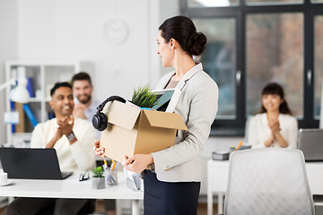 Image showing happy female office worker with personal stuff